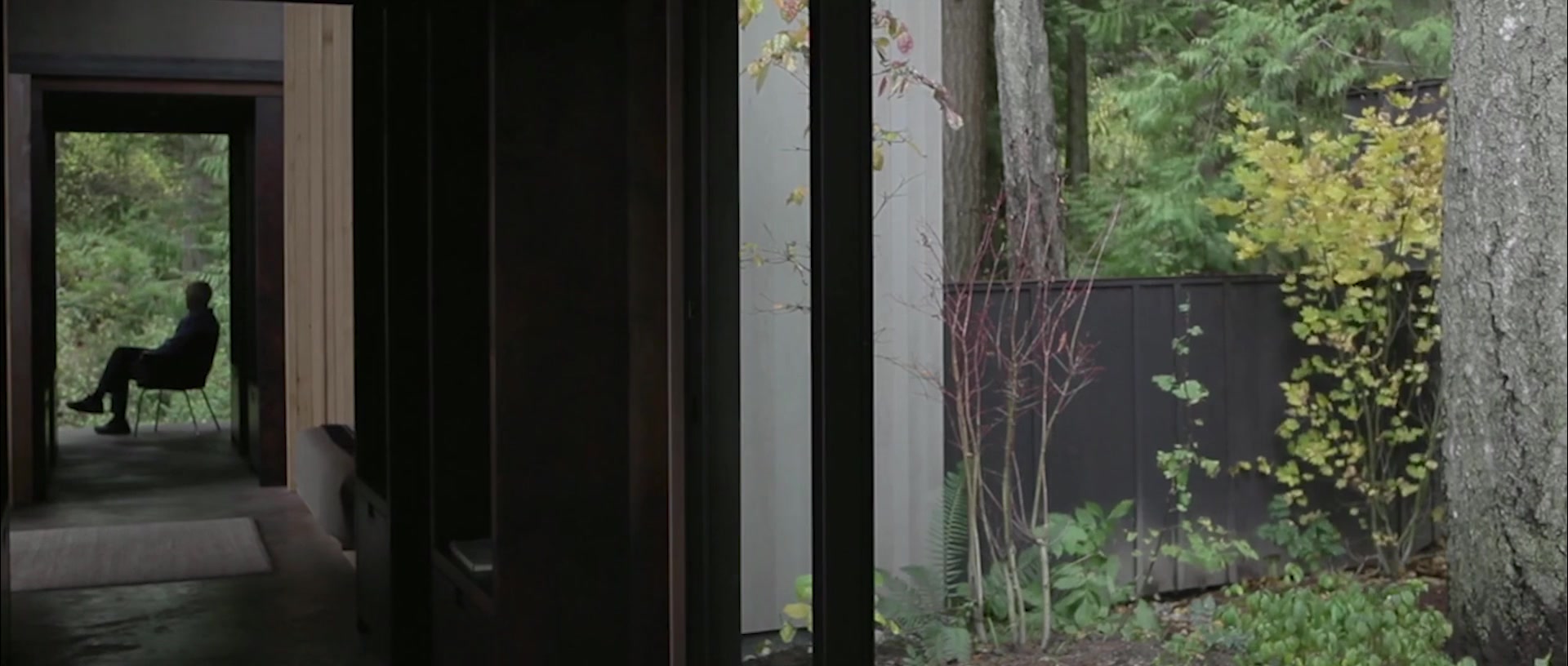 A home opening onto green trees and a garden