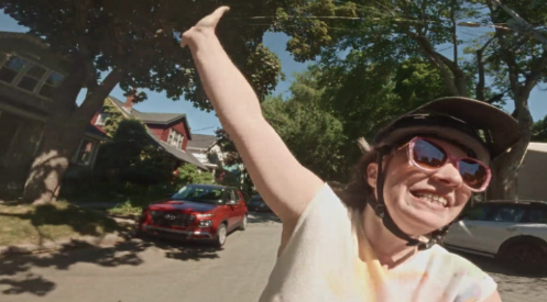 Christa Couture waving during her travels