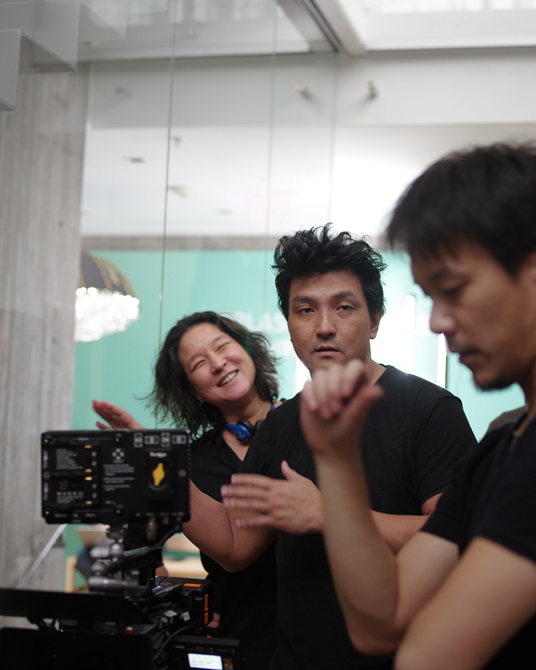 Members of the production team working around a camera monitor